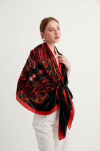 Charger l&#39;image dans la galerie, Discover the harmony of tradition and contemporary elegance with this timeless crepe silk shawl. This large shawl with mythological motifs, radiates warmth through red, black and white main colours, evoking a vibrant energy and life-giving power .
