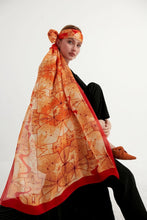 Load image into Gallery viewer, Discover the harmony of tradition and contemporary elegance with this timeless crepe silk shawl. This large shawl radiates warmth through its red, orange and beige sunset colours, evoking a vibrant energy and life-giving power.
