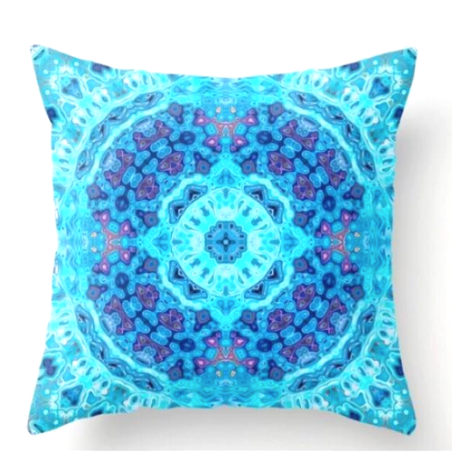 Front view of square %100 pure silk throw pillow, designed specially with fractal formulas and hand manufactured in limited numbers. Has a central circular shaped main motif with dominant colors of turquoise, blue and purple. Printed on both sides.